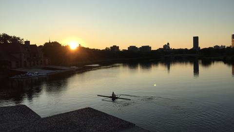 A lone sculler on the Charles River at dawn