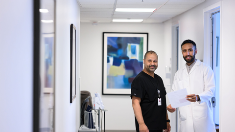 Two clinicians standing in the hallway of HUHS