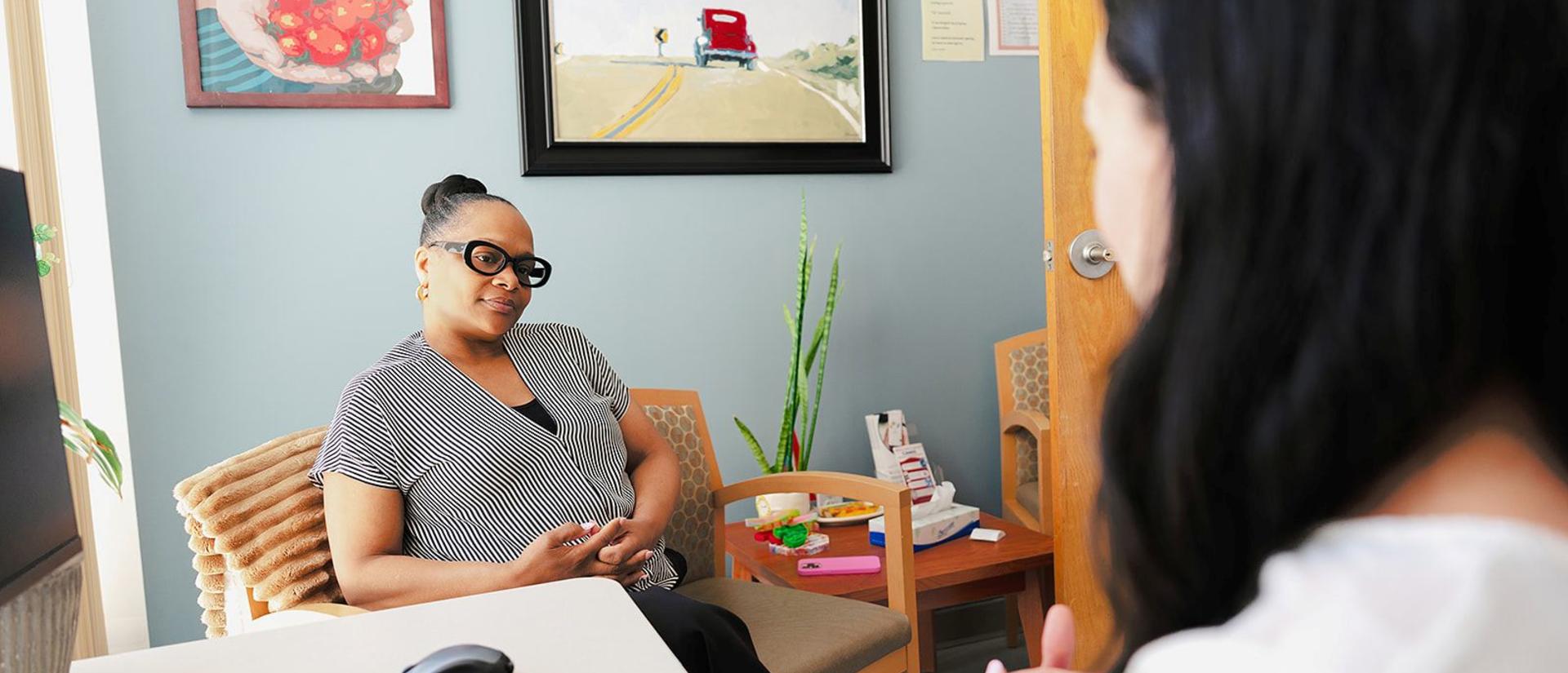 Dietitian sitting with a client in an office setting