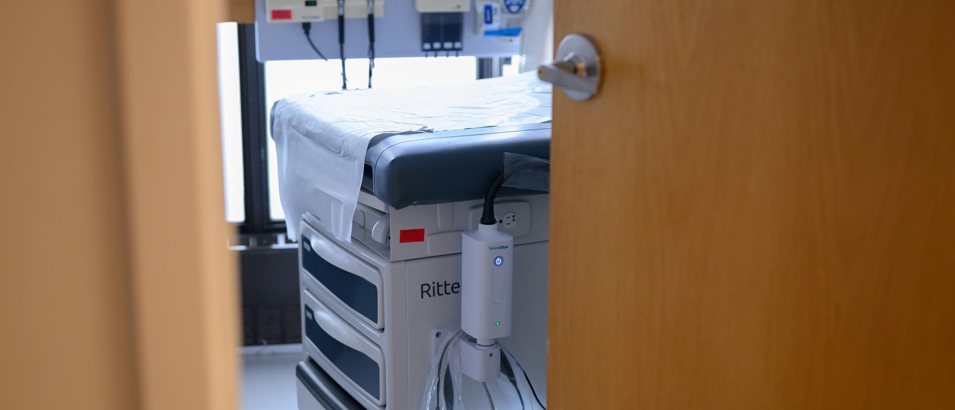 View of an HUHS exam room, as seen from the outside and framed by the door