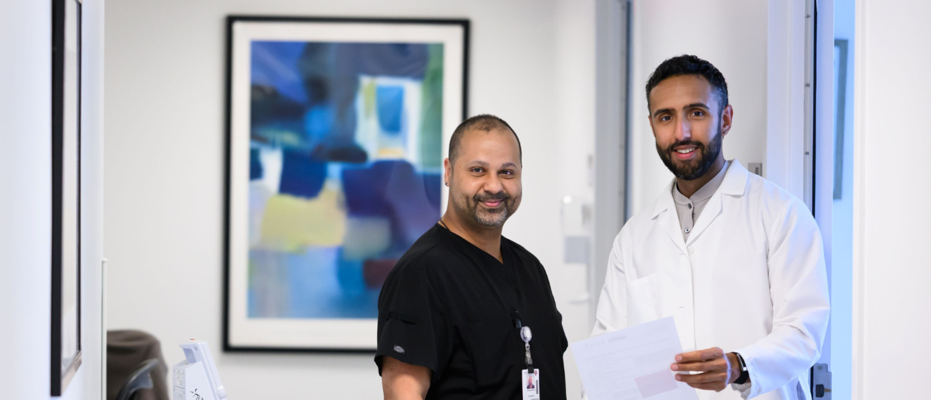 Two clinicians standing in the hallway of HUHS